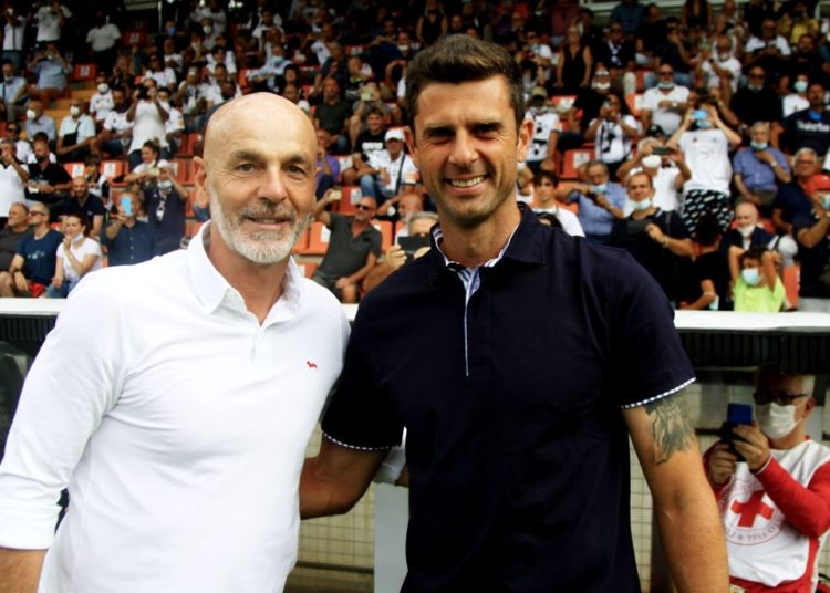 Thiago Motta of Spezia and Stefano Pioli of AC Milan