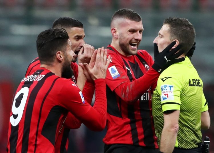 AC Milan players and referee Marco Serra