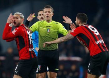 Daniele Orsato and AC Milan players