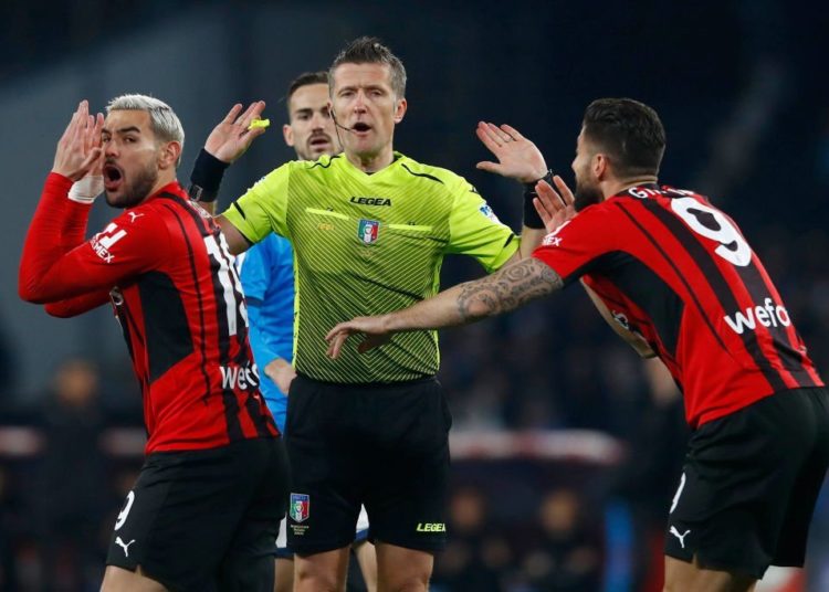 Daniele Orsato and AC Milan players