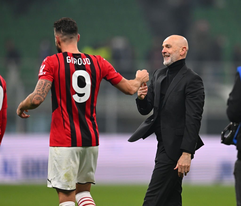 Olivier Giroud and Stefano Pioli of AC Milan