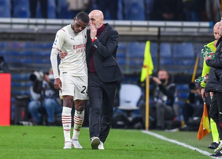 Pierre Kalulu and Stefano Pioli of AC Milan