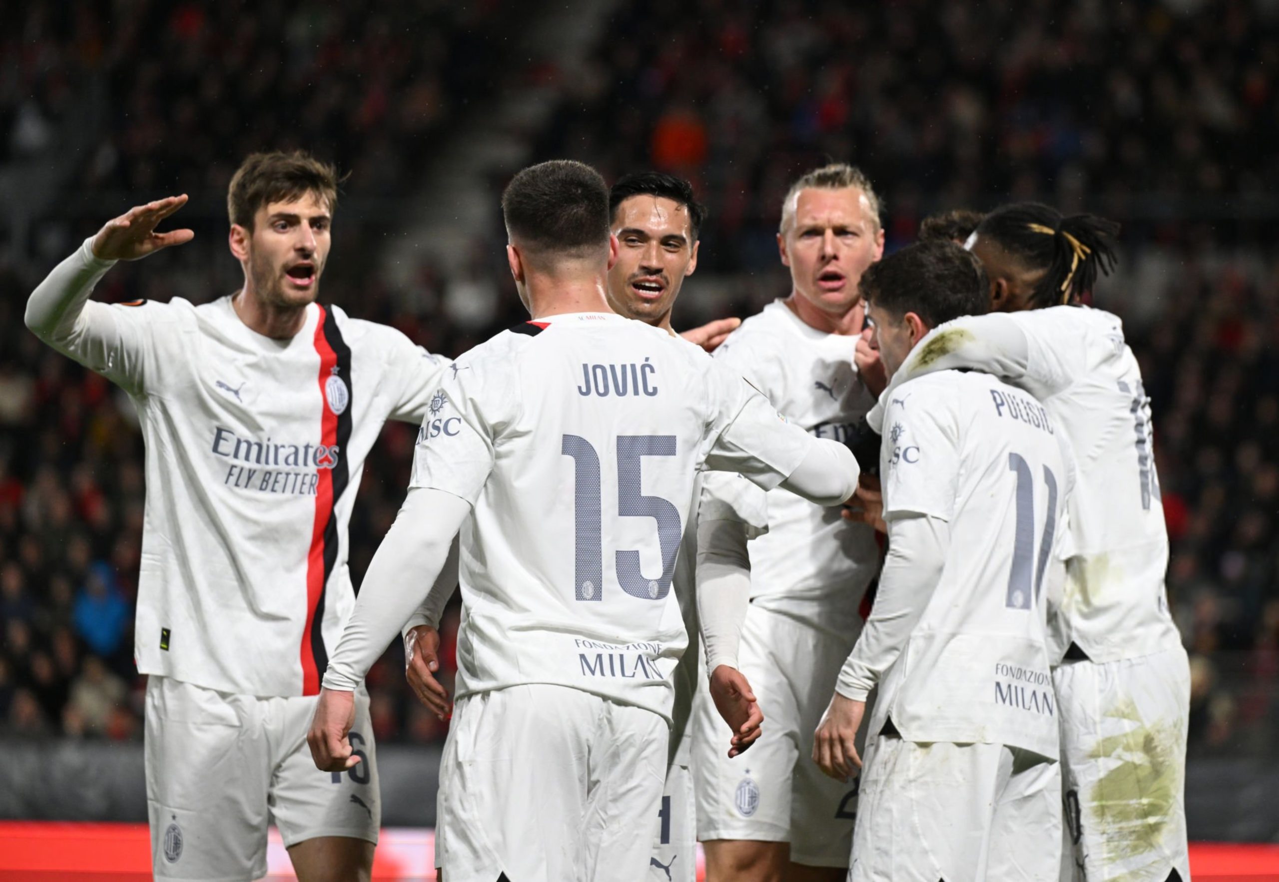 AC Milan players celebrate after scoring a goal