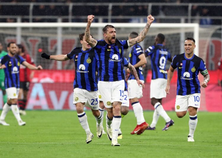 Francesco Acerbi celebrates after scoring against Milan in the derby at San Siro on April 22, 2024.
