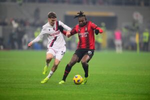 Bologna's Alexis Saelemaekers vies for the ball with AC Milan's Rafael Leao