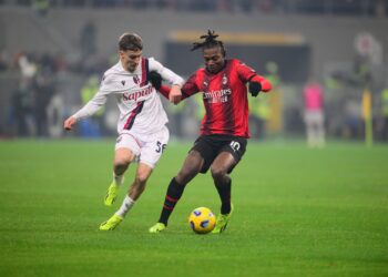 Bologna's Alexis Saelemaekers vies for the ball with AC Milan's Rafael Leao