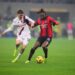 Bologna's Alexis Saelemaekers vies for the ball with AC Milan's Rafael Leao