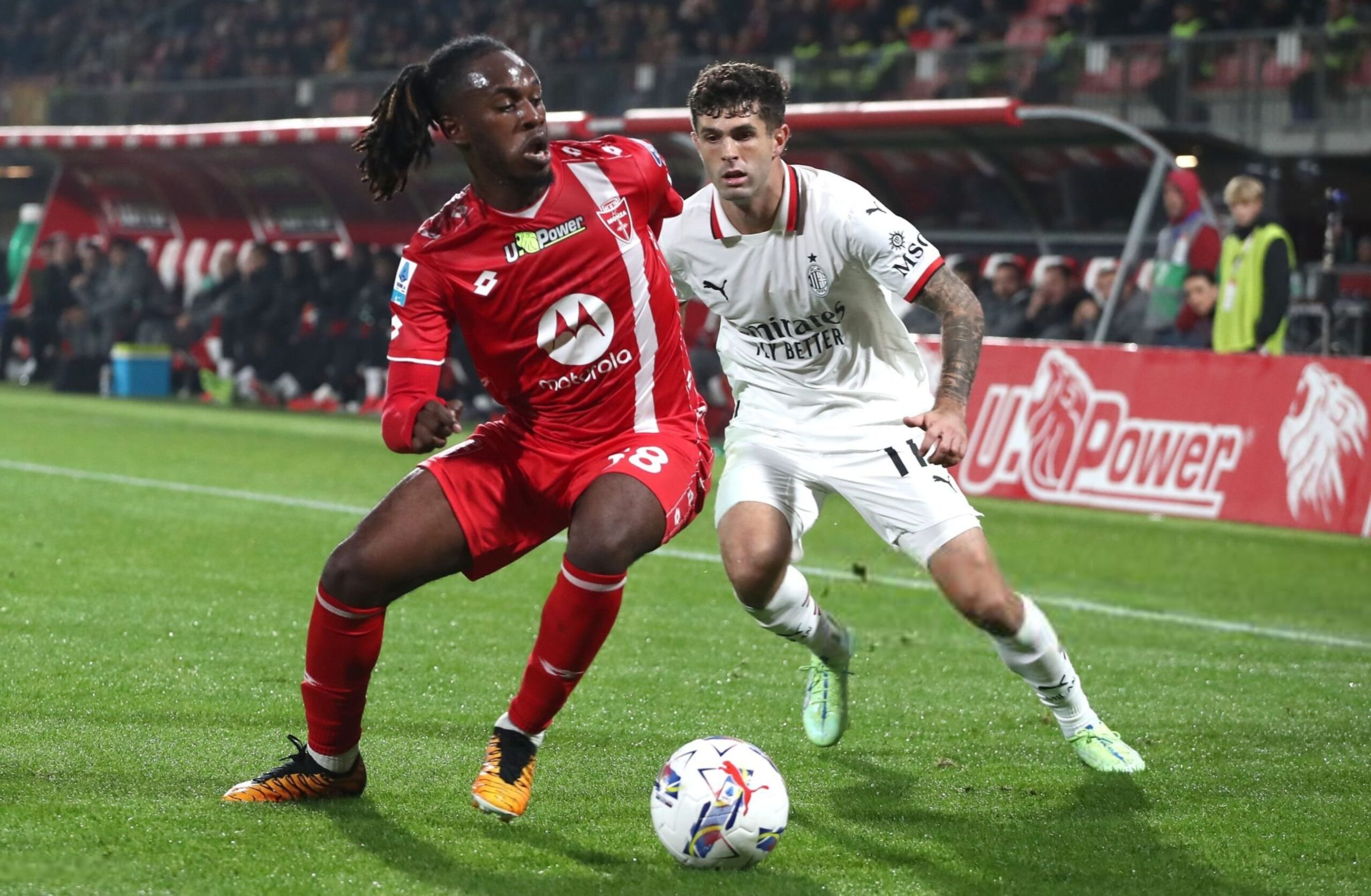 Monza's Warren Bondo with AC Milan's Christian Pulisic 