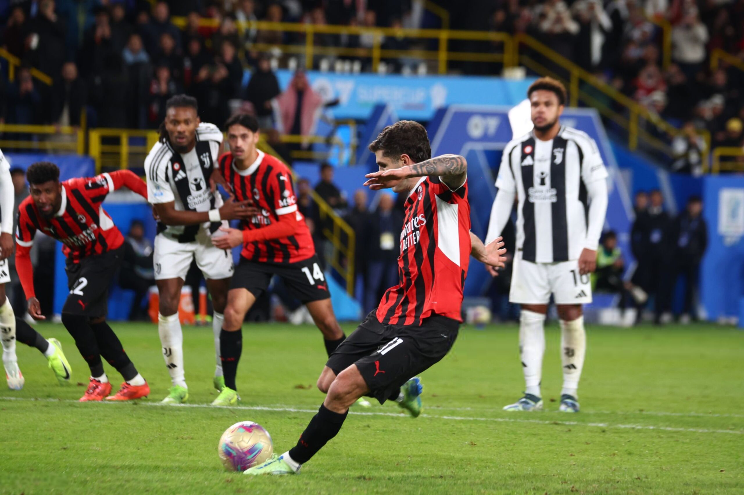 AC Milan's Chrisitan Pulisic shoots and scores a penalty against Juventus