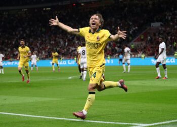 Luka Modric celebrates after scoring a goal for AC Milan against Bologna (Getty Images)