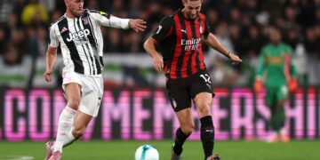 AC Milan's Adrien Rabiot and Dusan Vlahovic of Juventus