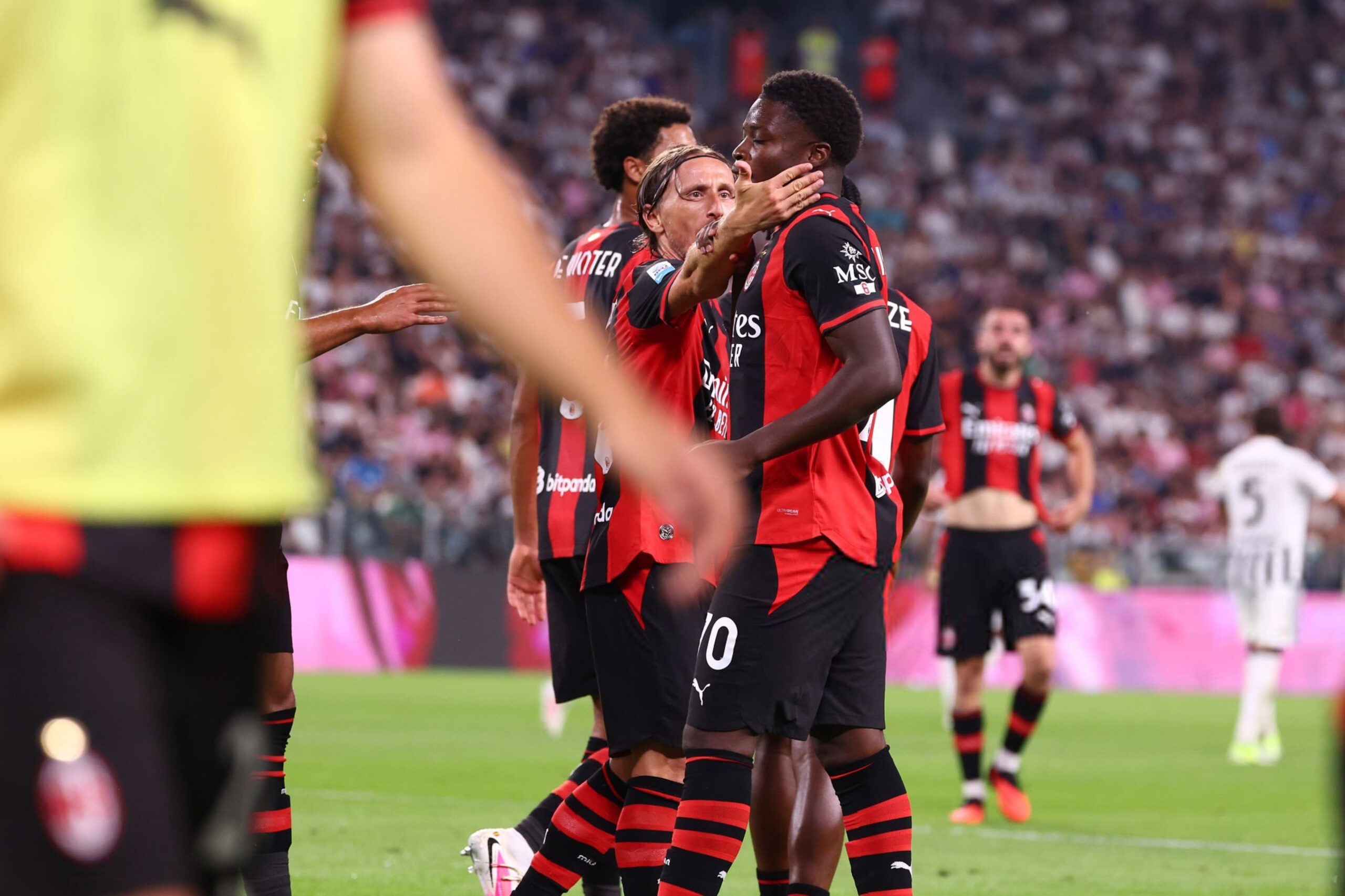 Luka Modric, Alphadjo Cisse and AC Milan teammates celebrate a goal scored against Juventus