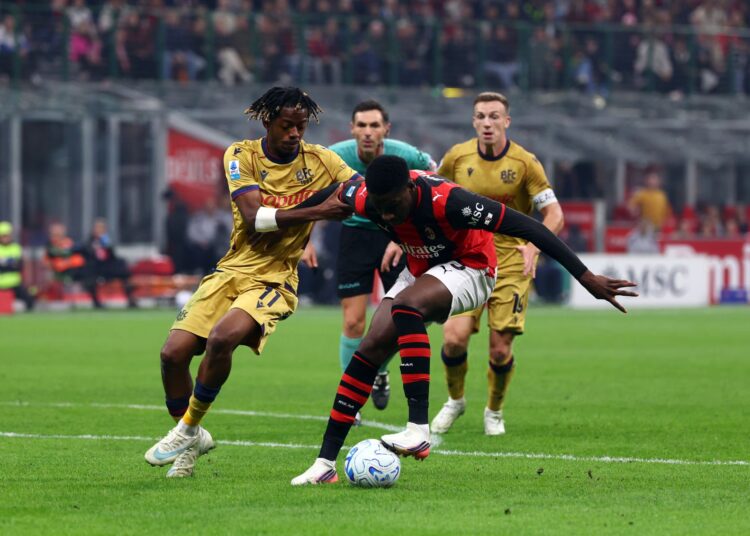 Sankhoun Diawara of AC Milan battles for the ball with Samuel Mbangula of Bologna FC