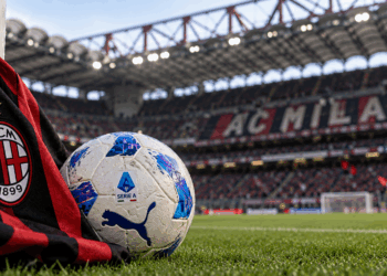AC Milan scarf and Serie A football at San Siro Stadium.